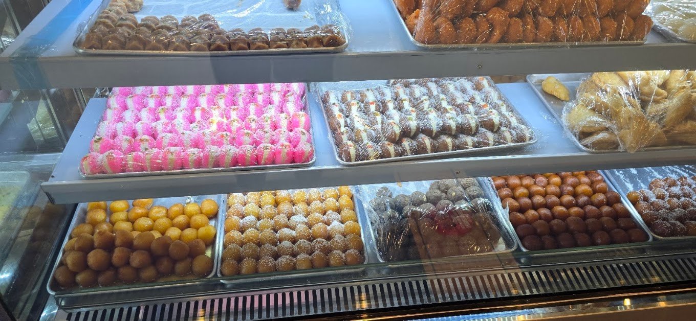 Vibrant display of gulab jamun, cham cham, and ladoos