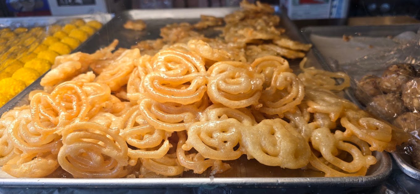 Fresh hot glossy Jalebis straight from the fryer