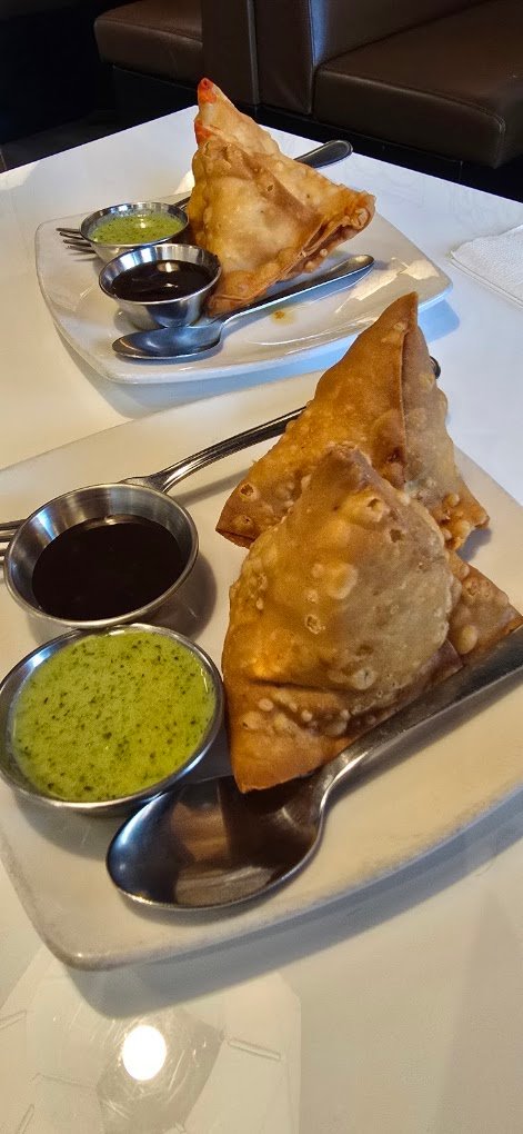 Crispy vegetable samosa served with mint and tamarind chutneys