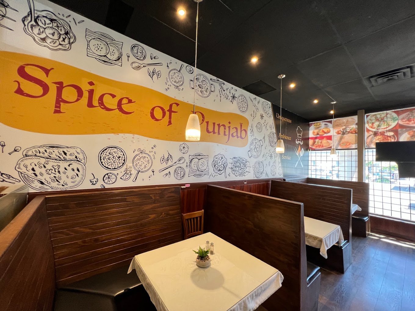Spice of Punjab welcoming dining booths and hand-painted wall art
